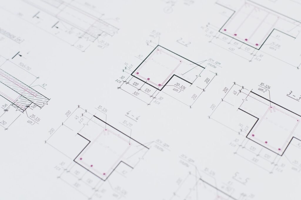 High-resolution close-up of detailed architectural blueprints showcasing precision design layouts.